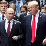 US President Donald Trump and Russias President Vladimir Putin talk during the family photo session at the APEC Summit in Danang Vietnam - برفيلكس - brieflex العصر الإمبراطوري الجديد.. كيف يغير ترامب وبوتين وشي النظام العالمي؟ - برفيلكس - brieflex