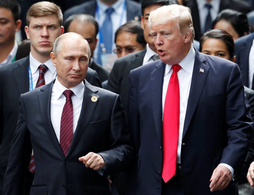 US President Donald Trump and Russias President Vladimir Putin talk during the family photo session at the APEC Summit in Danang Vietnam - برفيلكس - brieflex العصر الإمبراطوري الجديد.. كيف يغير ترامب وبوتين وشي النظام العالمي؟ - برفيلكس - brieflex