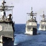 Line of gray military ships sailing in formation across the ocean (Reuters photo). - برفيلكس - brieflex