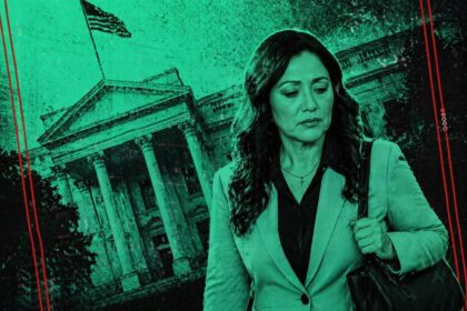 Woman in a blazer carrying a shoulder bag walks past a neoclassical government building with columns, in a teal-toned edit.