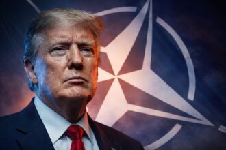 Close-up of a stern older man in a dark suit and red tie, with a large NATO emblem backdrop.