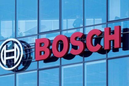 Bosch logo on a blue glass office building, with the circular emblem to the left of red 'BOSCH' lettering. (Brand sign) - برفيلكس - brieflex